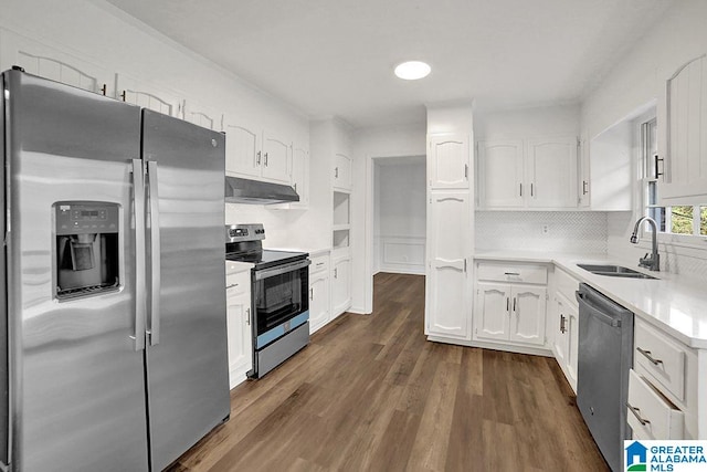 kitchen featuring light countertops, appliances with stainless steel finishes, white cabinets, a sink, and under cabinet range hood