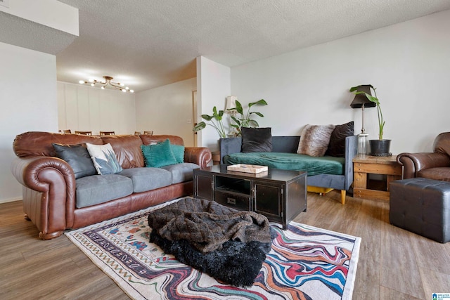 living room featuring a textured ceiling and light hardwood / wood-style floors