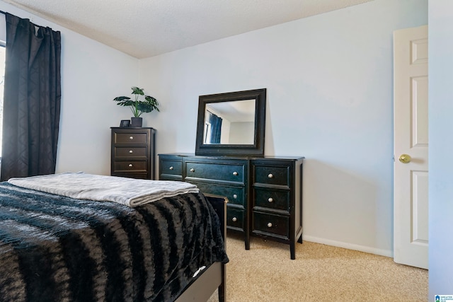 bedroom with light colored carpet