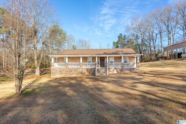 ranch-style home featuring a porch and a front lawn