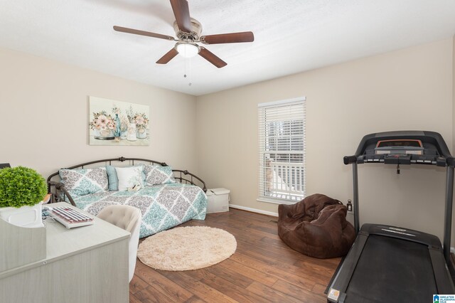 bedroom with dark hardwood / wood-style flooring and ceiling fan