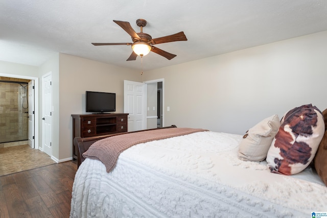 bedroom with ceiling fan, dark hardwood / wood-style flooring, and ensuite bath