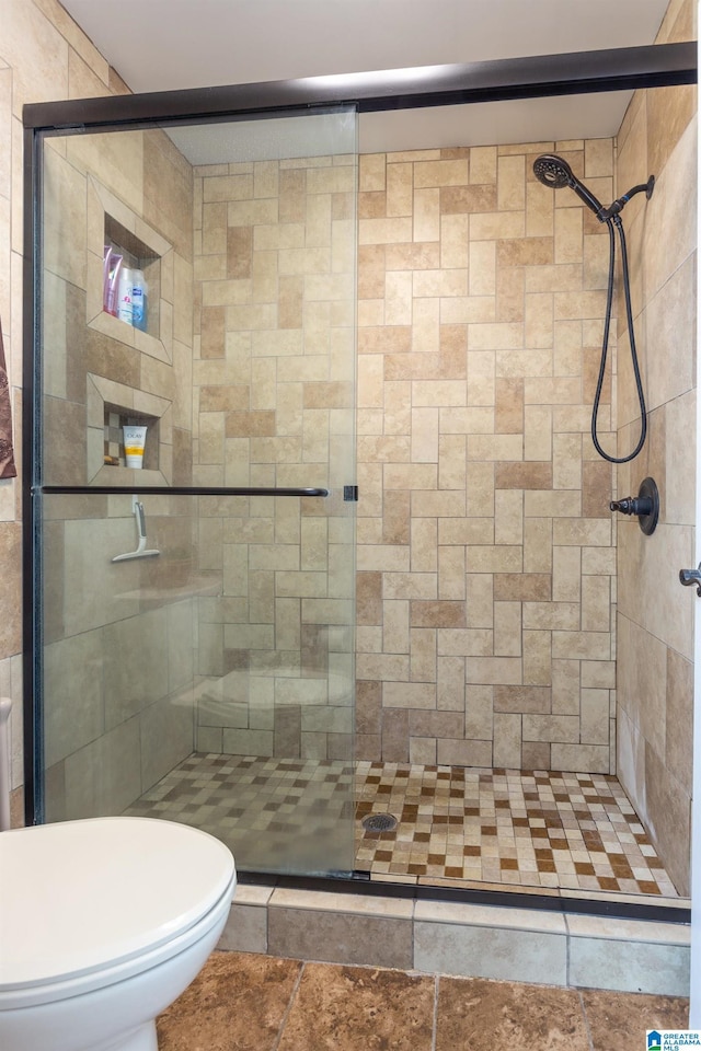 bathroom featuring an enclosed shower and toilet