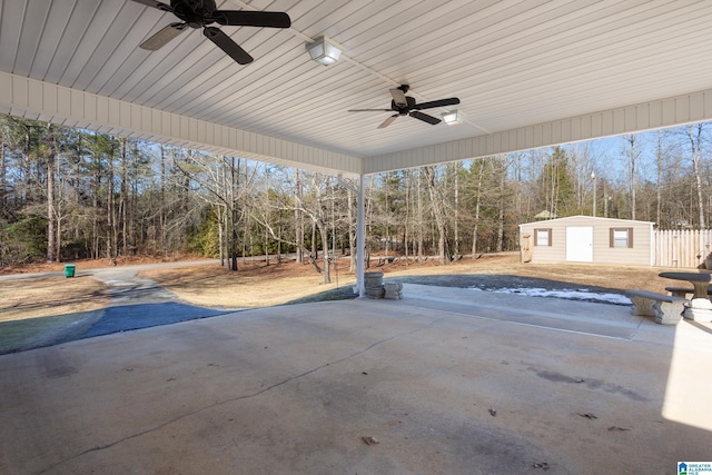 view of patio with ceiling fan and an outdoor structure