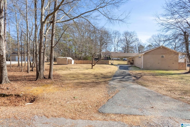 exterior space with a carport and a storage shed