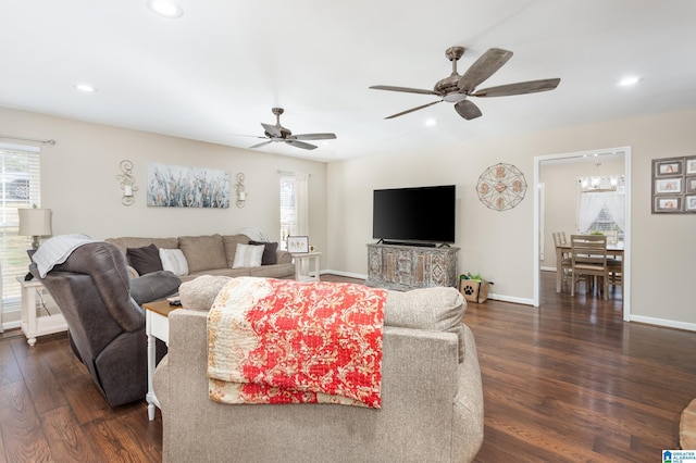 living room featuring ceiling fan and dark hardwood / wood-style floors