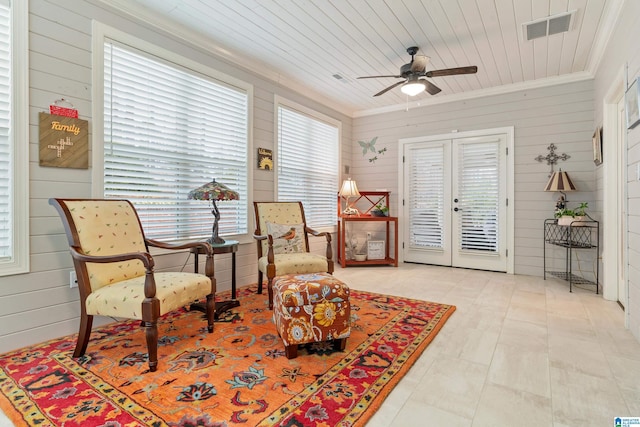 living area with wood walls, french doors, and wood ceiling