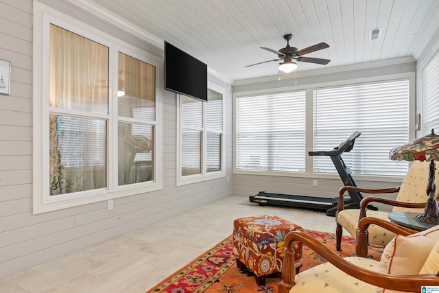 sunroom featuring ceiling fan, wood ceiling, and a healthy amount of sunlight