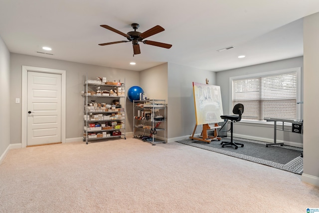 exercise area featuring carpet floors and ceiling fan