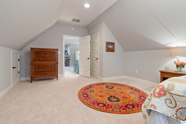 carpeted bedroom with vaulted ceiling