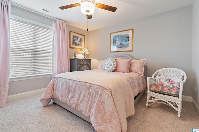 bedroom with light carpet and ceiling fan