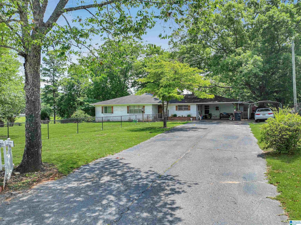 single story home featuring a carport and a front yard