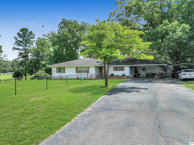 ranch-style home featuring a carport and a front yard