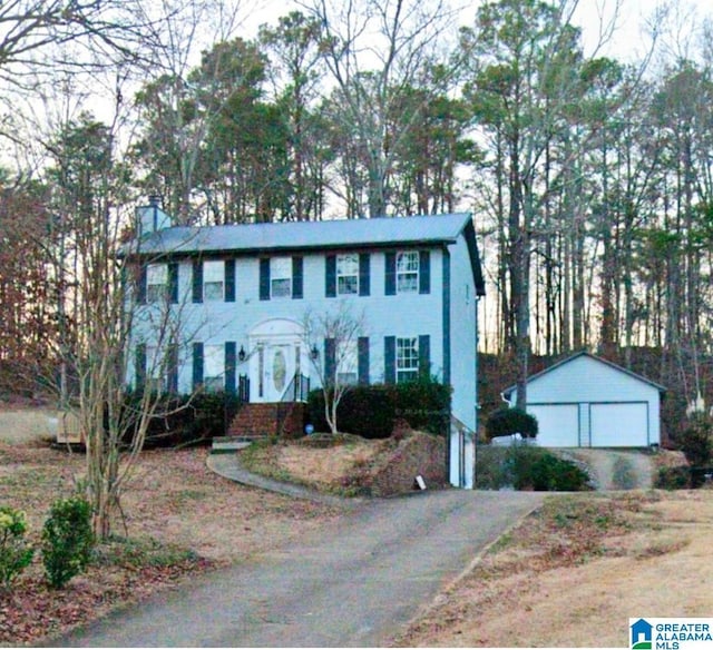 colonial-style house with an outbuilding and a garage