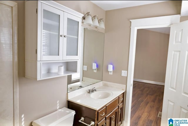 bathroom featuring hardwood / wood-style flooring, vanity, and toilet