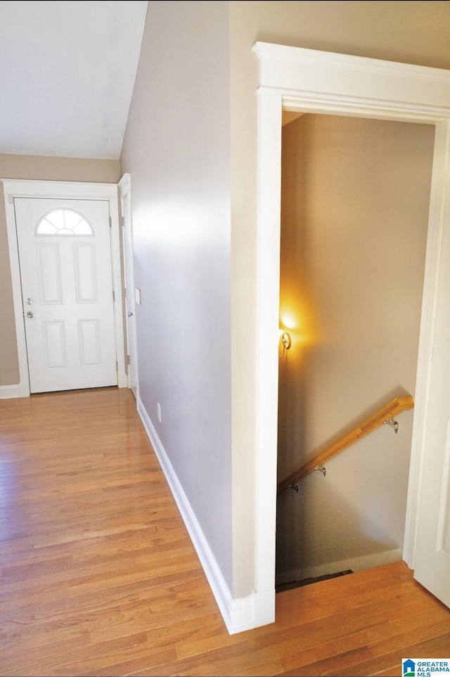 interior space with light hardwood / wood-style floors and vaulted ceiling