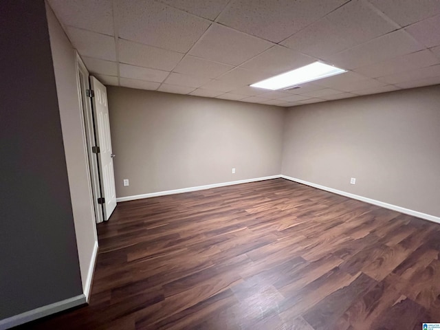 unfurnished room featuring a paneled ceiling and dark wood-type flooring