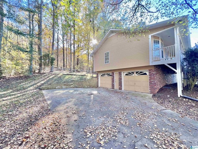 view of side of home with a balcony and a garage