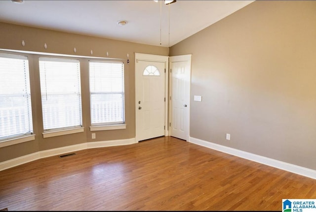 entrance foyer featuring lofted ceiling and hardwood / wood-style flooring