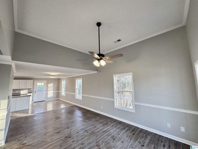 unfurnished living room with hardwood / wood-style flooring, a textured ceiling, ceiling fan, and crown molding