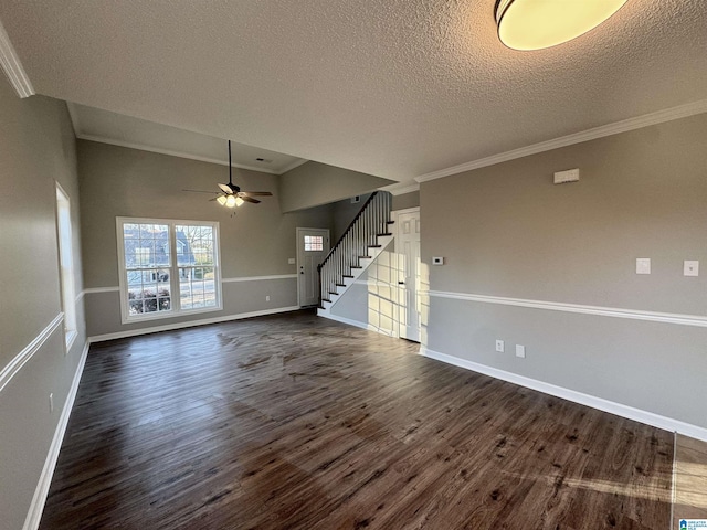 interior space featuring a textured ceiling, dark hardwood / wood-style flooring, ornamental molding, and ceiling fan