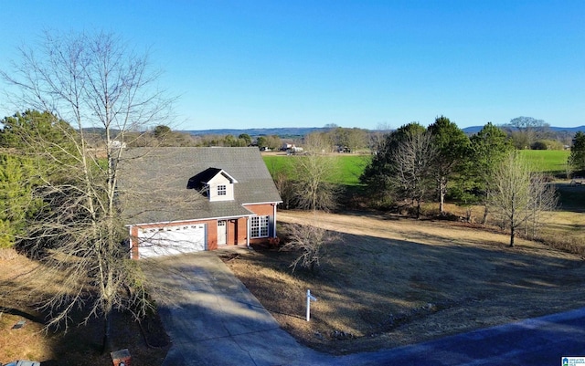 view of front facade with a rural view and a garage