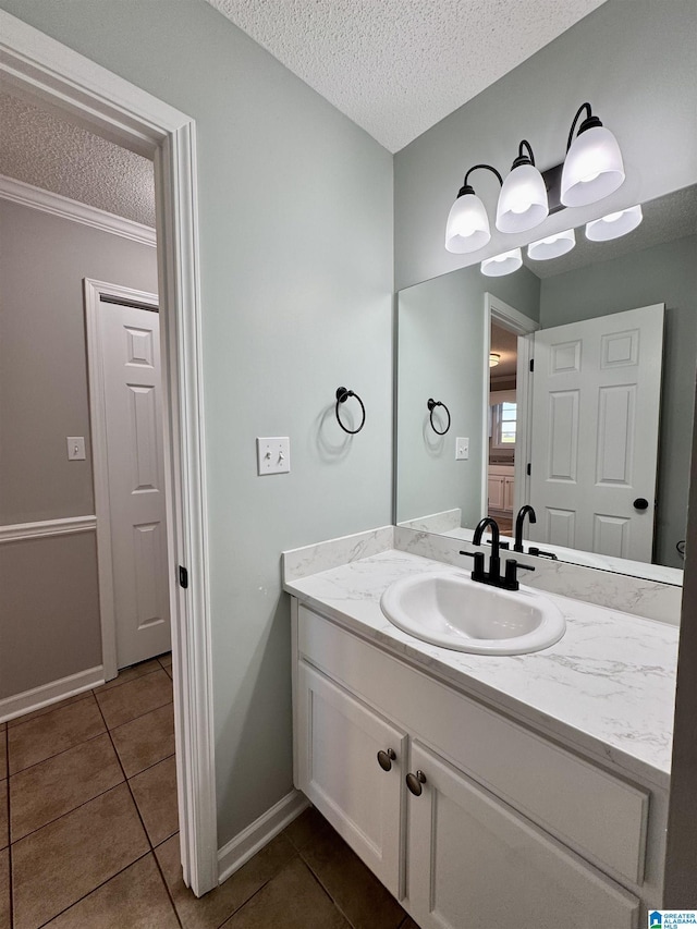 bathroom featuring a textured ceiling, vanity, and tile patterned floors