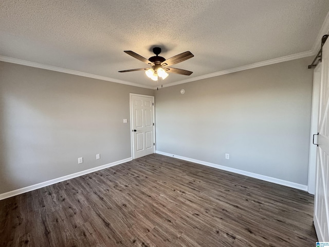 spare room with a textured ceiling, dark hardwood / wood-style flooring, ornamental molding, and ceiling fan