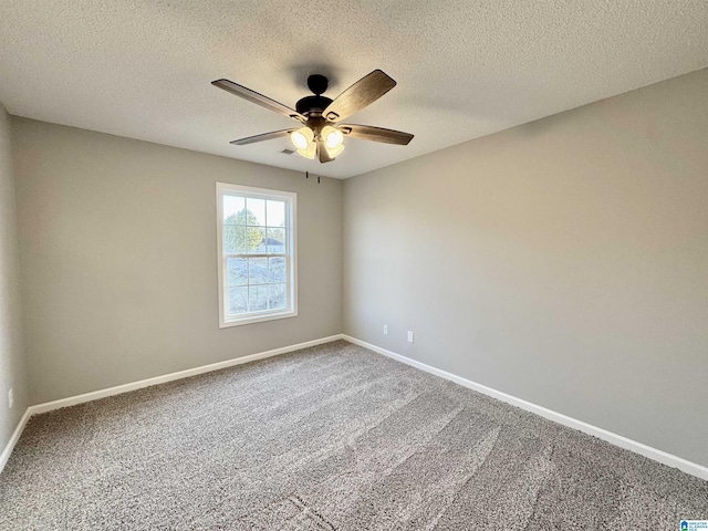 carpeted empty room with a textured ceiling and ceiling fan