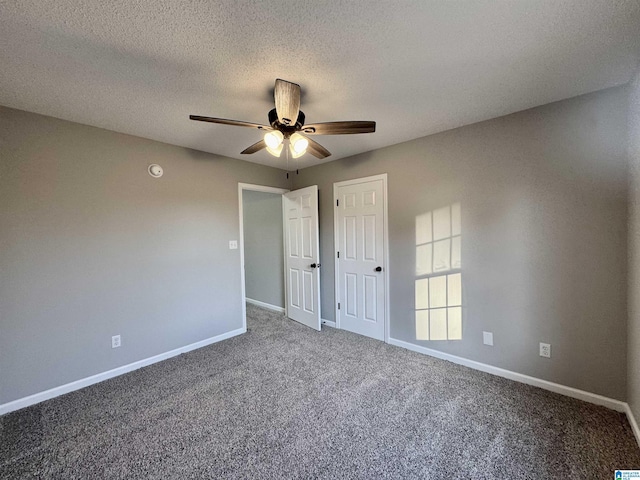 unfurnished bedroom featuring a textured ceiling, carpet floors, and ceiling fan