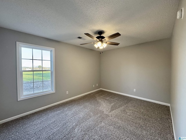 carpeted empty room with a textured ceiling and ceiling fan