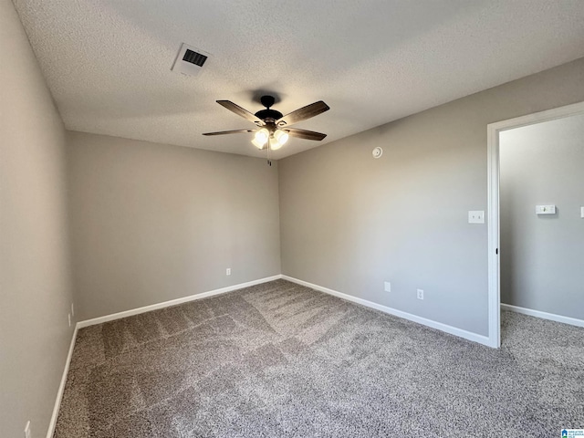 carpeted spare room with a textured ceiling and ceiling fan