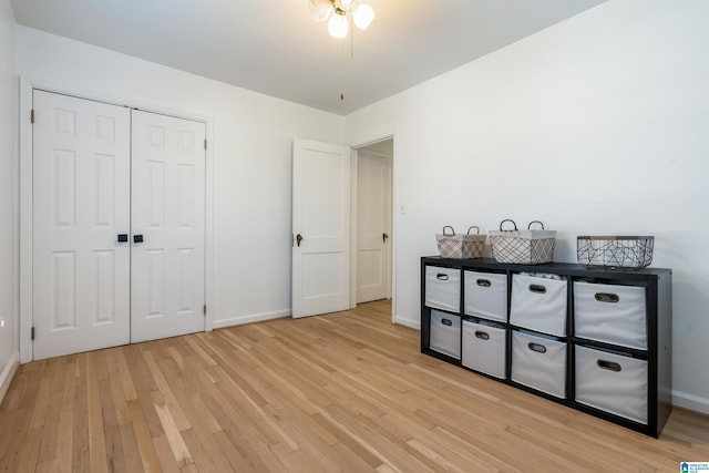 unfurnished bedroom with light hardwood / wood-style flooring and a closet