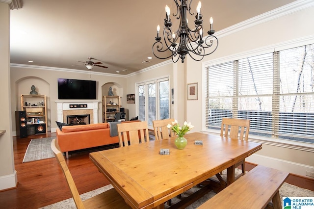 dining area featuring hardwood / wood-style flooring, ornamental molding, and ceiling fan