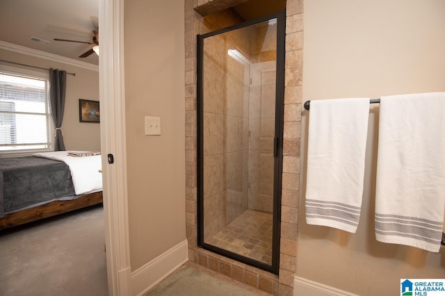 bathroom with ceiling fan, ornamental molding, and a shower with door