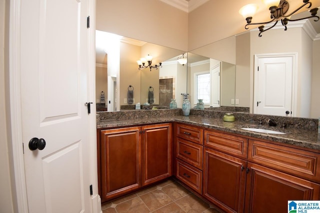 bathroom featuring tile patterned floors, vanity, ornamental molding, and a chandelier