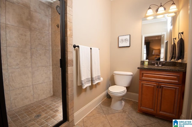 bathroom featuring toilet, vanity, tile patterned floors, and a shower with door