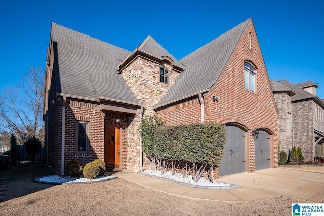 tudor house featuring a garage