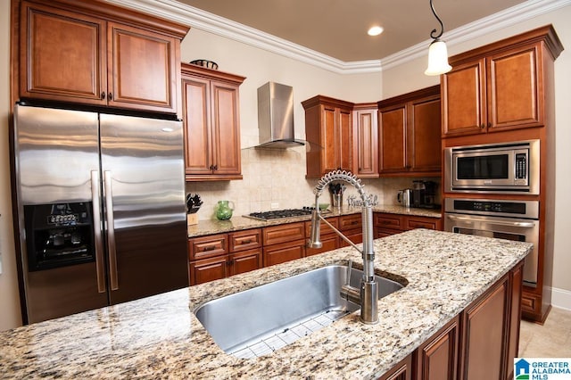 kitchen featuring appliances with stainless steel finishes, wall chimney exhaust hood, hanging light fixtures, and light stone countertops