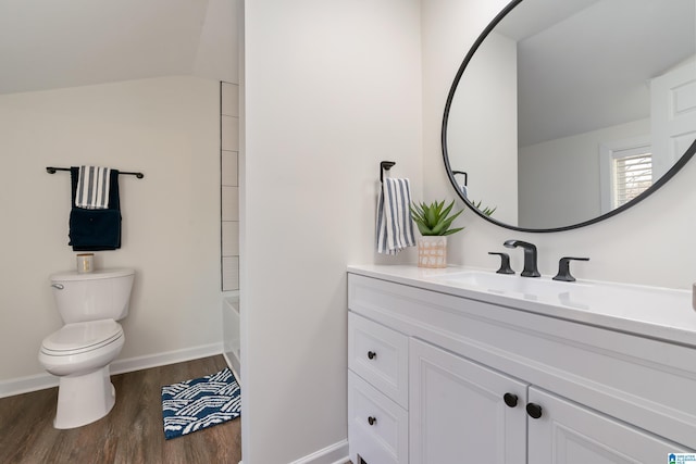 full bathroom with toilet, vanity, hardwood / wood-style floors, and bathing tub / shower combination