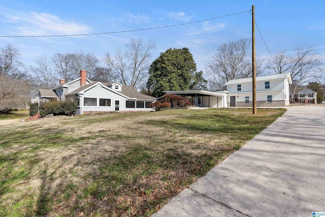 exterior space with a front yard and a carport