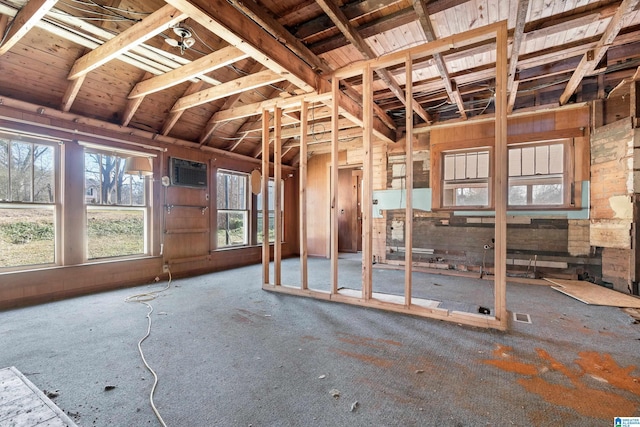 miscellaneous room featuring a wall unit AC, wooden ceiling, and vaulted ceiling with beams