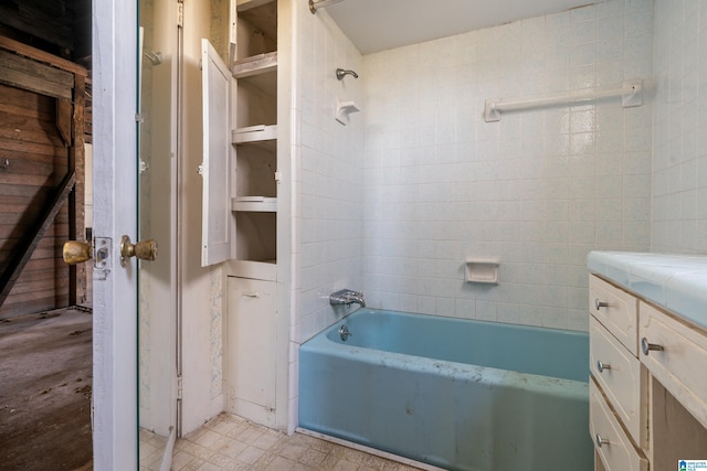 bathroom with vanity and tiled shower / bath combo