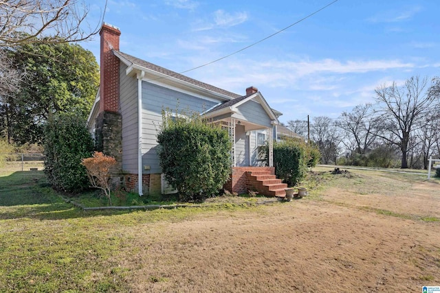 view of side of home with a lawn