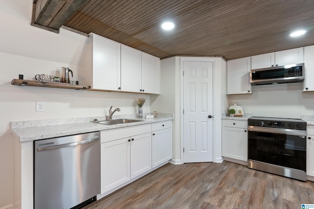 kitchen featuring hardwood / wood-style flooring, stainless steel appliances, wood ceiling, white cabinetry, and sink