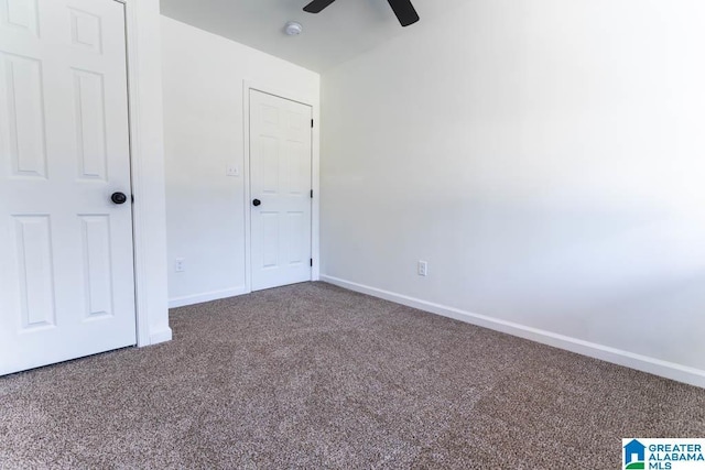 unfurnished bedroom featuring ceiling fan and carpet