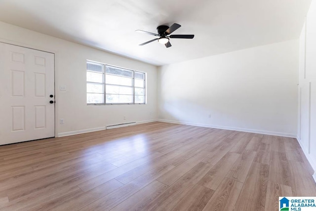 foyer entrance featuring a baseboard radiator, ceiling fan, and light hardwood / wood-style flooring