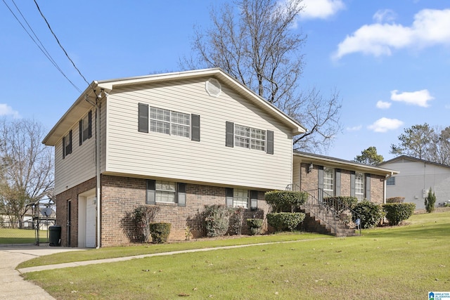 split level home with a front yard and a garage