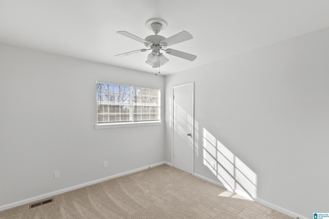 unfurnished room featuring ceiling fan and light colored carpet