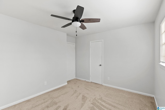 unfurnished room with light carpet and ceiling fan